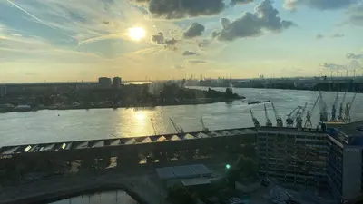 a view of a river with the sun in the sky at Charming modern apartment in the heart of Antwerp with optional private parking in Antwerp