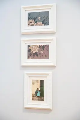 three framed photographs on a wall in a white wall at Cire Bed and Breakfast in Meerhout