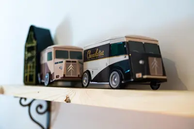 two toy trucks are sitting on a shelf at Cire Bed and Breakfast in Meerhout
