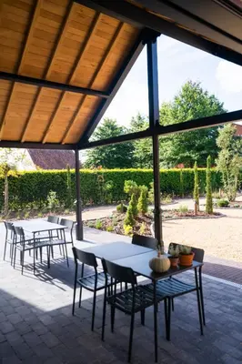 a group of tables and chairs on a patio at Cire Bed and Breakfast in Meerhout