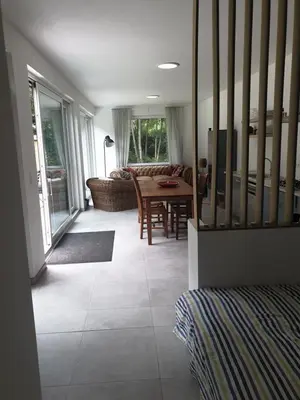 a living room with a couch and a table at Eden in Sint-Pauwels