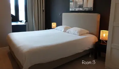 a bedroom with a white bed with two lamps at 3 Room Luxury Design Apartment with Airconditioning, Close to Gent St-Pieters Station in Ghent