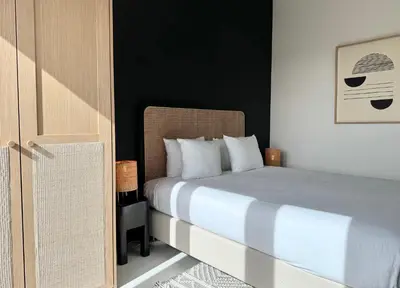 a bedroom with a bed with white pillows at 3 Room Luxury Design Apartment with Airconditioning, Close to Gent St-Pieters Station in Ghent