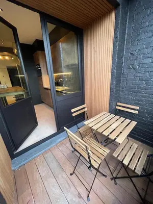 a wooden bench and a table on a porch at 3 Room Luxury Design Apartment with Airconditioning, Close to Gent St-Pieters Station in Ghent