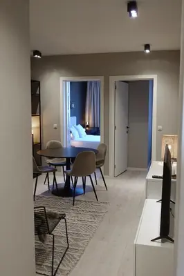 a living room with a table and a bedroom at 3 Room Luxury Design Apartment with Airconditioning, Close to Gent St-Pieters Station in Ghent