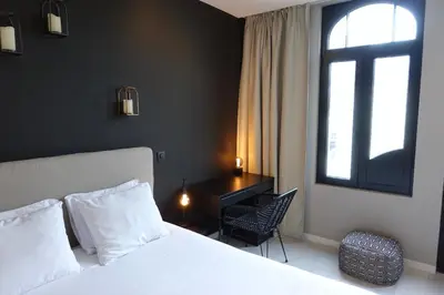 a bedroom with a bed and a desk and a window at 3 Room Luxury Design Apartment with Airconditioning, Close to Gent St-Pieters Station in Ghent