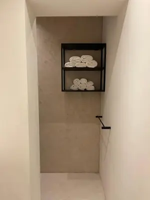 a hallway with a shelf with towels on it at 3 Room Luxury Design Apartment with Airconditioning, Close to Gent St-Pieters Station in Ghent