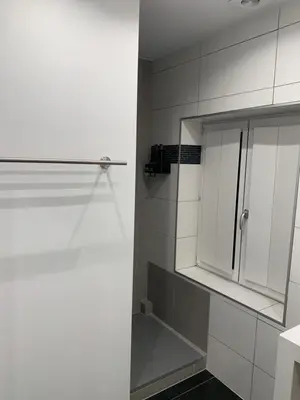 a bathroom with a shower with a white cabinet at B&B Silentium in Tielt