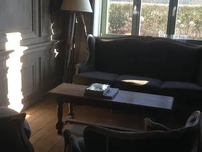a living room with a couch and a coffee table at B&B Silentium in Tielt