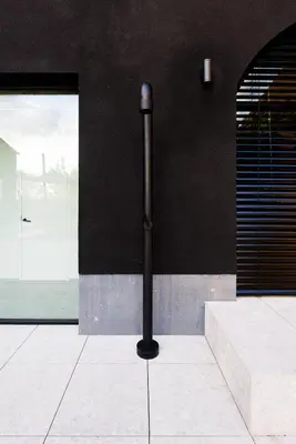 a black wall with a pipe on the side of a building at Holiday Home L'O Reine - with luxury wellness in Sint-Pieters-Leeuw