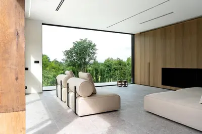 a bedroom with white furniture and a large window at Holiday Home L'O Reine - with luxury wellness in Sint-Pieters-Leeuw
