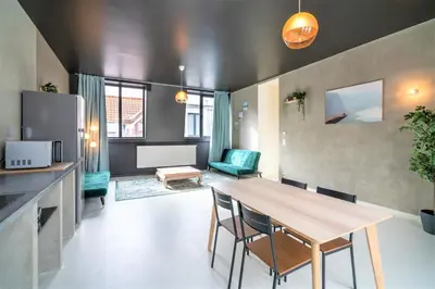 a kitchen and living room with a table and chairs at Antwerps Central Residence in Antwerp