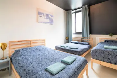 a bedroom with two beds and a window at Antwerps Central Residence in Antwerp