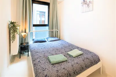a bedroom with a bed with two pillows on it at Antwerps Central Residence in Antwerp