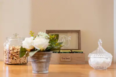 a vase with flowers in it sitting on a table at Cozy Apartment Brussels Centre in Brussels