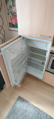 an empty refrigerator with its door open in a kitchen at Cozy Apartment Brussels Centre in Brussels
