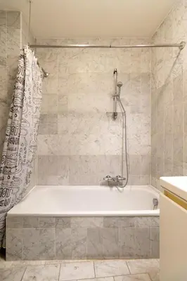 a white bath tub in a bathroom with a shower at Cozy Apartment Brussels Centre in Brussels