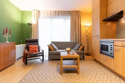 a living room with a couch and a chair at Cozy Apartment Brussels Centre in Brussels