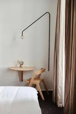 a bedroom with a table and a table and a bed at Edgar Guesthouse in Ghent