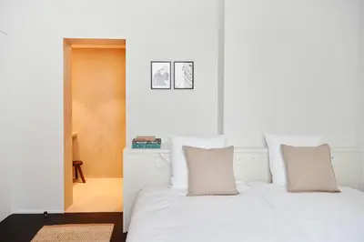 a bedroom with two beds with white sheets and pillows at Edgar Guesthouse in Ghent