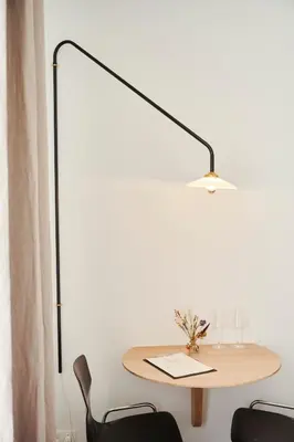 a table with a lamp and two chairs at Edgar Guesthouse in Ghent