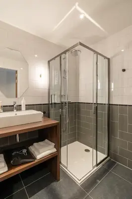 a bathroom with a shower and a sink at YAYS Antwerp Opera by Numa in Antwerp