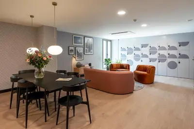 a living room with a table and chairs and a couch at YAYS Antwerp Opera by Numa in Antwerp