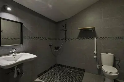 a bathroom with a sink and a toilet and a mirror at Domein Warandehof in Gooik