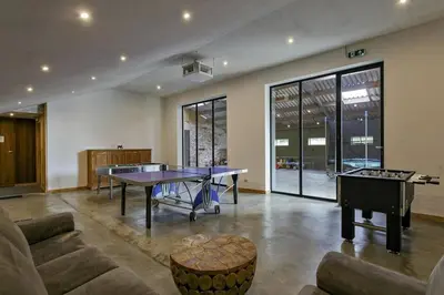 a living room with two ping pong tables and a piano at Domein Warandehof in Gooik
