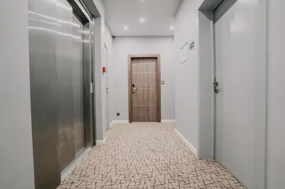 a hallway with a door and a tile floor at Hôtel Concorde in Brussels