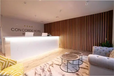 a living room with a coffee table and a counter at Hôtel Concorde in Brussels