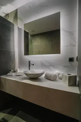 a bathroom counter with a sink and a mirror at Hôtel Concorde in Brussels