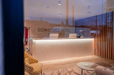 a room with a counter and a table in a room at Hôtel Concorde in Brussels