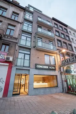 a building with a sign on the front of it at Hôtel Concorde in Brussels