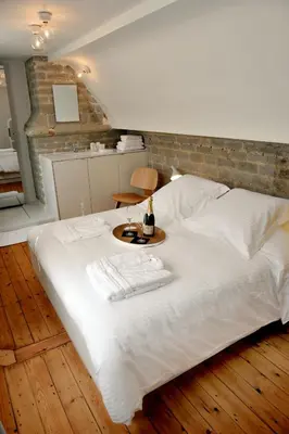a large white bed with a table on it at Guesthouse Bernardin in Antwerp
