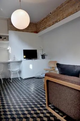 a living room with a couch and a tv at Guesthouse Bernardin in Antwerp