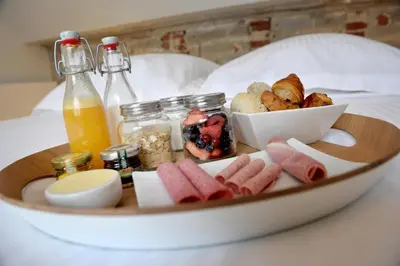 a tray of breakfast foods on a bed at Guesthouse Bernardin in Antwerp