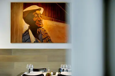 a painting of a man sitting at a table at Guesthouse Bernardin in Antwerp