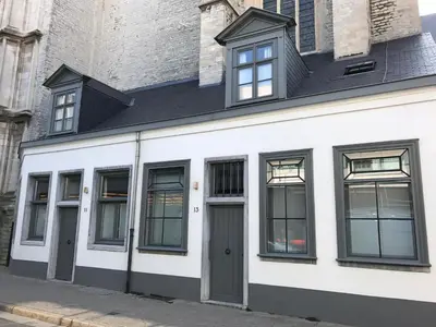 a white building with windows and a door at Guesthouse Bernardin in Antwerp