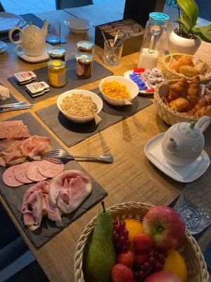 a table filled with food and fruits and other foods at BEUKENHOUSE in Drogenbos