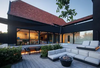 an outdoor patio with white couches and a table at Wellness Suite B&B L'O Reine in Sint-Pieters-Leeuw