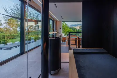 a house with a large glass door and a living room at Wellness Suite B&B L'O Reine in Sint-Pieters-Leeuw