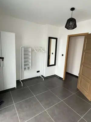 a room with white walls and a tiled floor at FDS Cosy Apartment in Ghent