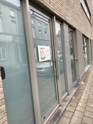 a sliding glass door of a building with a sign on it at FDS Cosy Apartment in Ghent