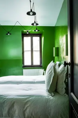 a green bedroom with a white bed and a window at La Maison Haute guesthouse in Brussels