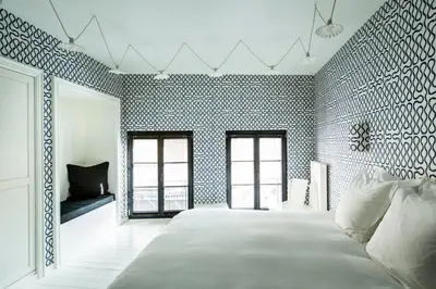 a bedroom with a large white bed in a room at La Maison Haute guesthouse in Brussels