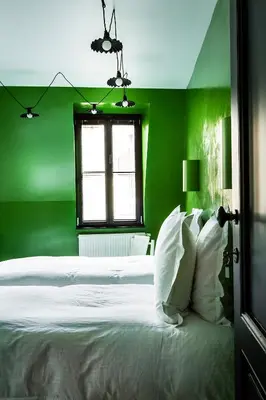 a green bedroom with a white bed and a window at La Maison Haute guesthouse in Brussels