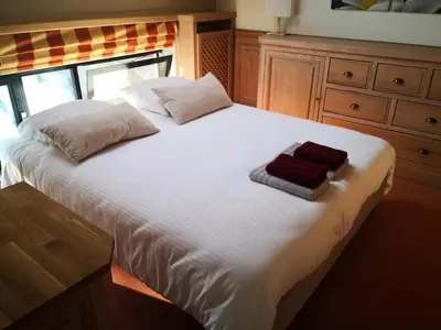 a large white bed with two pillows on it at Lakeview in Keerbergen
