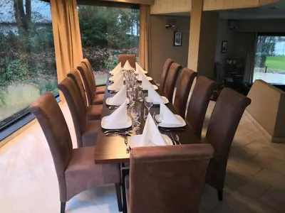 a long table in a restaurant with chairs and tablesearcher at Lakeview in Keerbergen