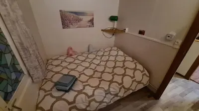a small bedroom with a bed in a room at Rent & Relax: De steiger in Geel